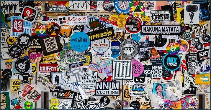 Creating a cohesive artist brand. Photo of lots of music artist stickers.