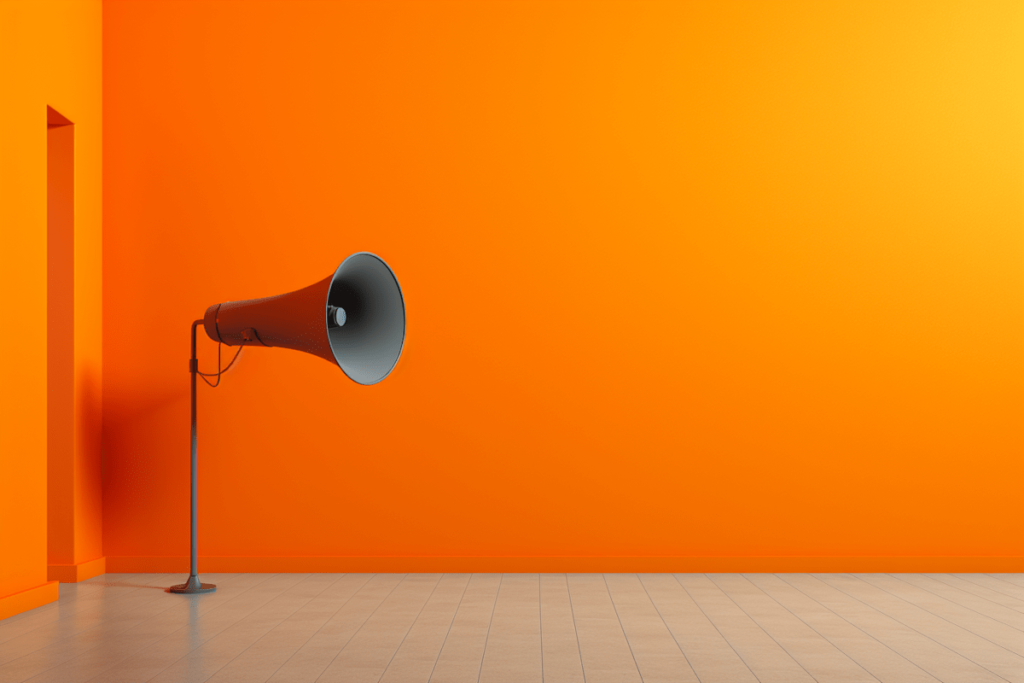 How to build a brand voice that people remember. Orange background, with megaphone on display.