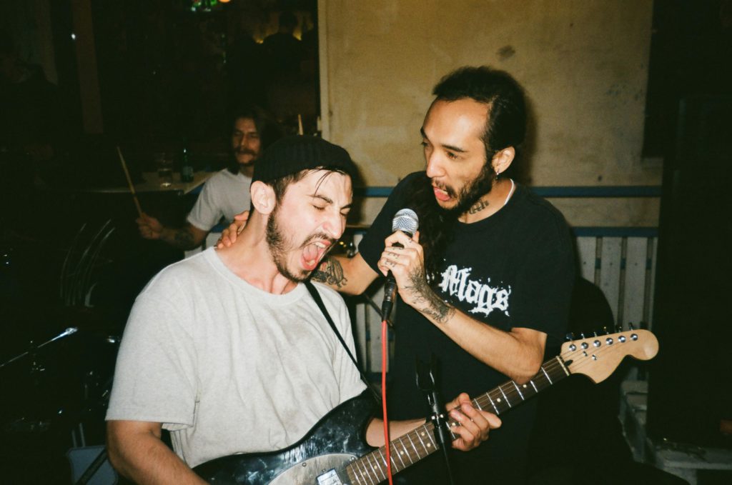 Breakout artists to watch this year. Photo of two people singing into a microphone.