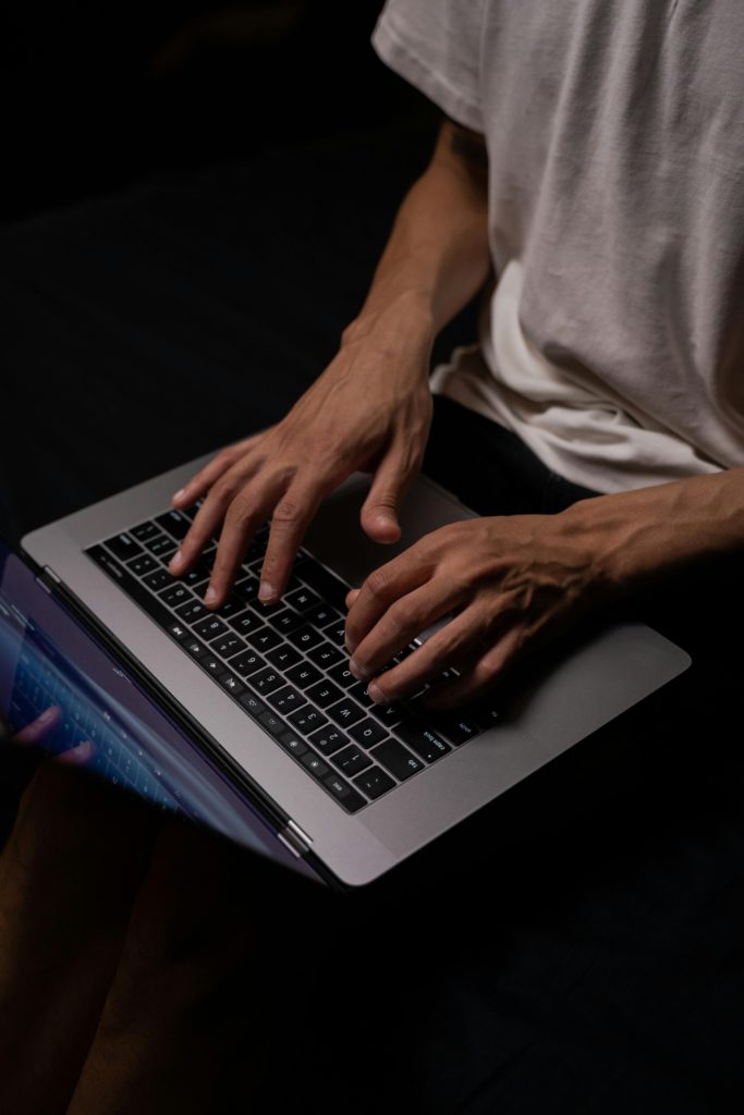 Video upload stuck at 95%? Troubleshooting social media upload problems. Photo of hands typing on a laptop.