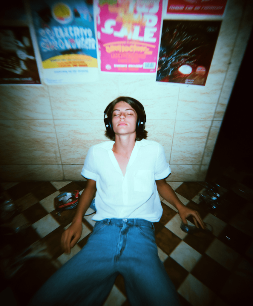 The best ways to promote your music on TikTok. Photo of a person on the floor with headphones on, blurred image.