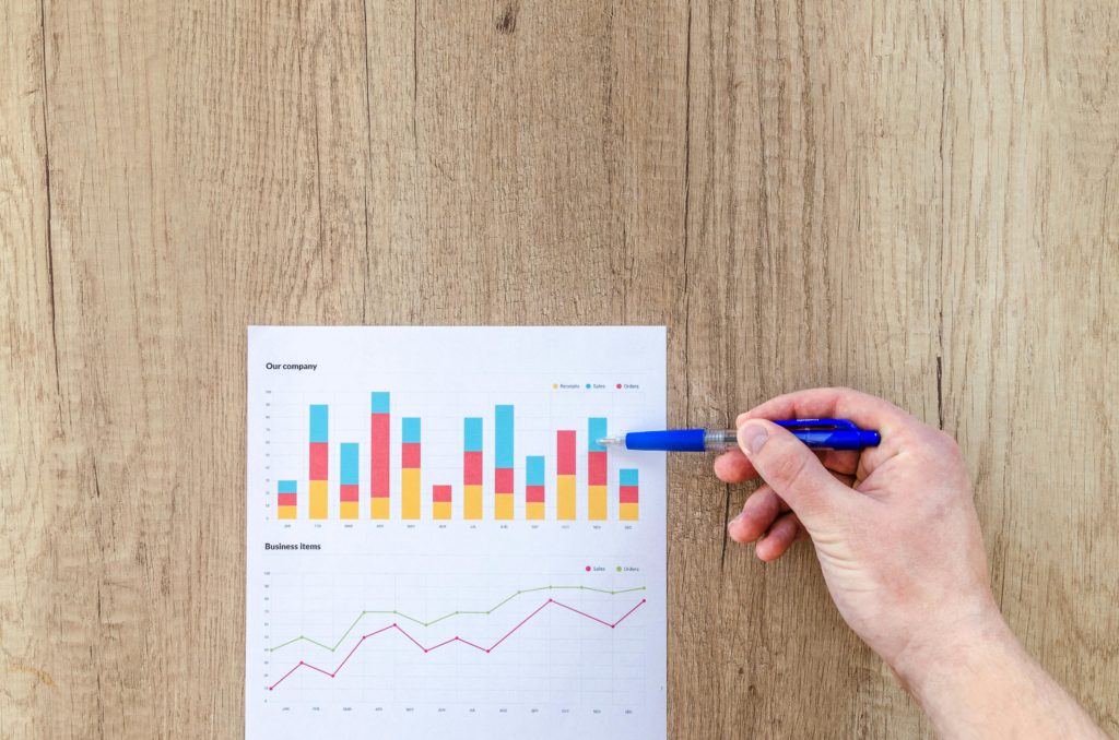 How the algorithm works (at a beginner level). Photo of a hand pointing a pen at a graph.
