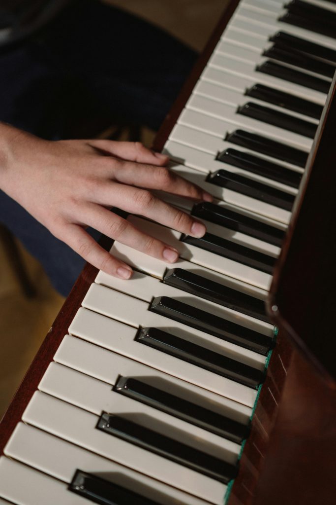 How to use modes and scales creatively. Keyboard with hand playing it.