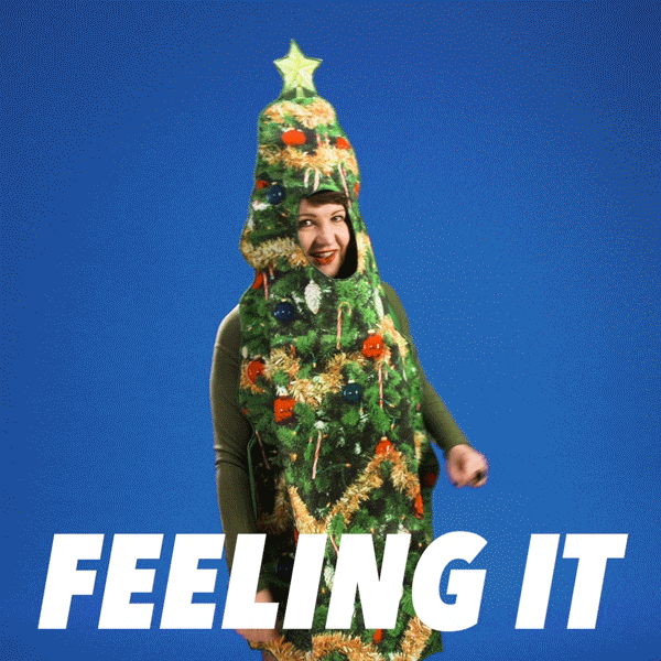 The best Christmas songs to cover as a beginner. GIF of someone dancing in a Christmas tree.