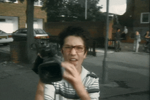 Should you reply with videos? A simple guide. GIF of someone holding a video camera.