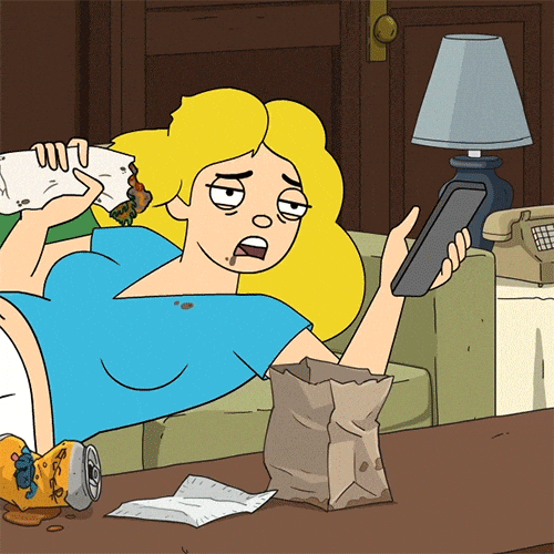 The art of working on music when motivation is low. GIF of a woman on the sofa, eating, and using the TV remote.