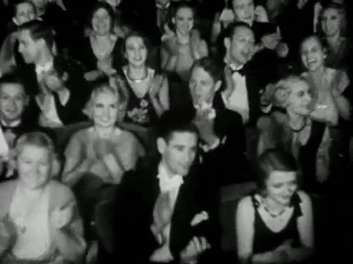 The power of the micro-community: why smaller is smarter. Black and white audience clapping GIF.