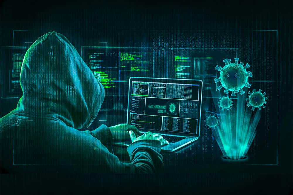 Cybersecurity strategies every business should adopt. Graphic of a hooded person at a desk.