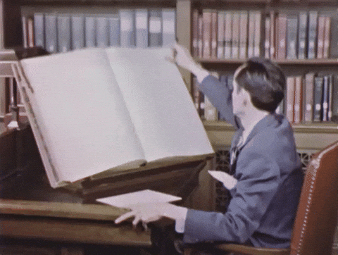 The social media glossary: 20 terms you need to know. Huge book being turned page by page GIF.